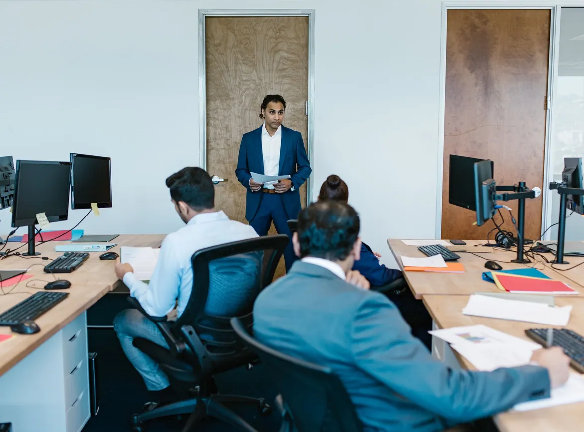 Business meeting with team in modern office space, discussing projects