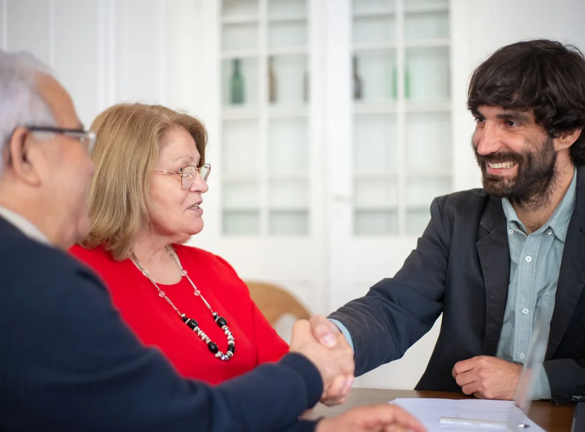 Business professionals engaged in a positive office meeting, sealing a deal with a handshake