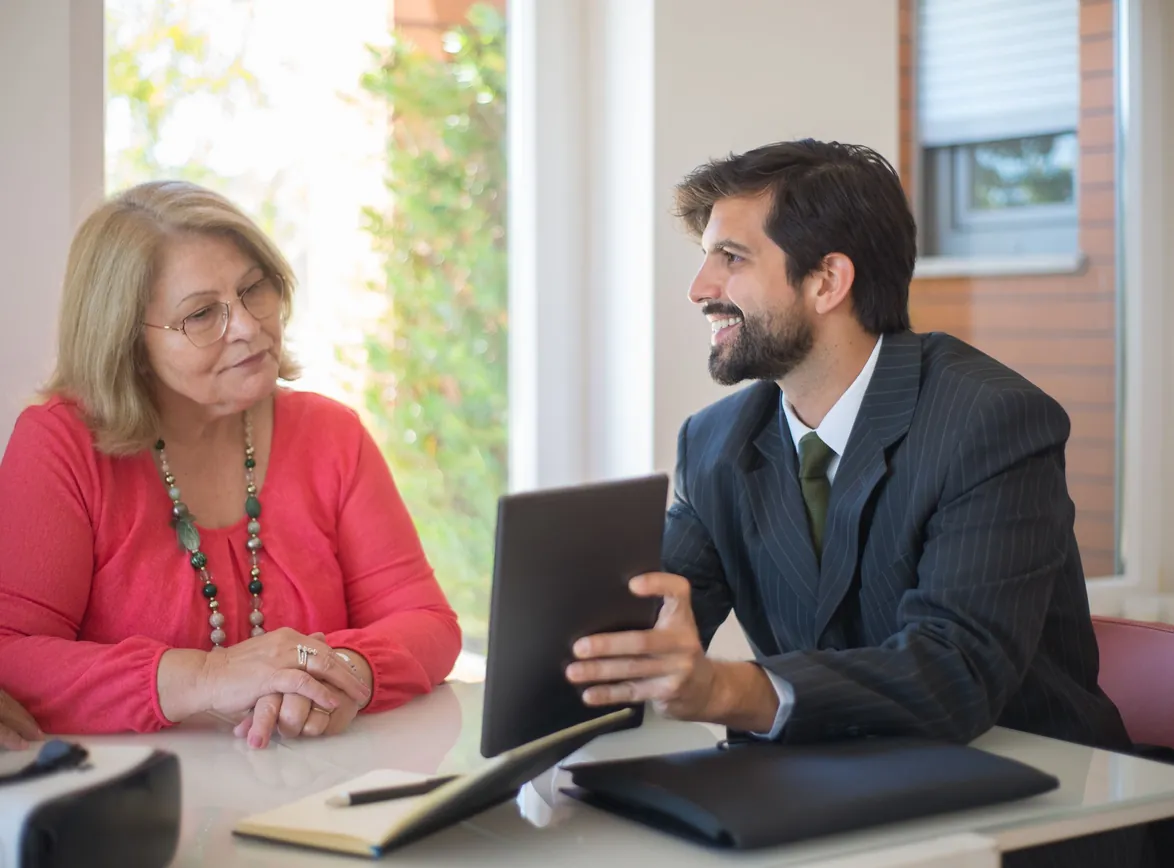 Elderly woman consulting with a advisor in a cozy indoor setting