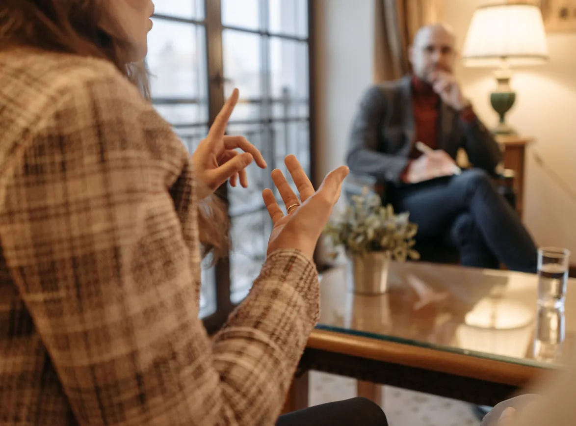 A man and woman engaged in a business conversation at an office setting