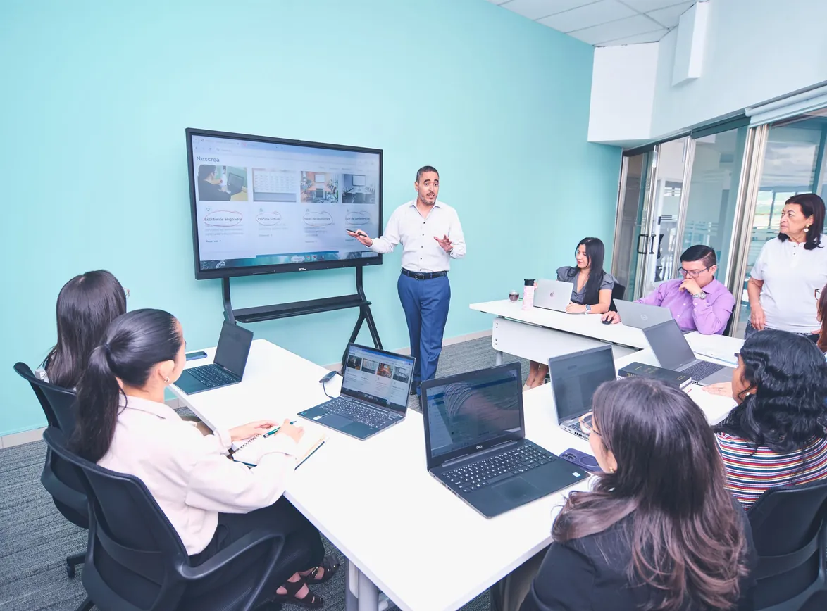 Team engaged in a presentation at a modern office using digital technology