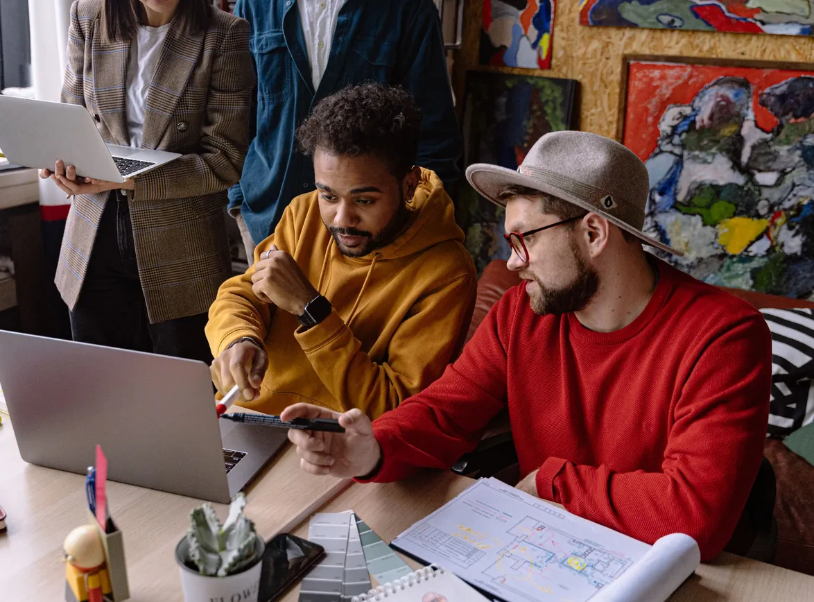 Team in casual attire collaborating on a project in a creative workspace