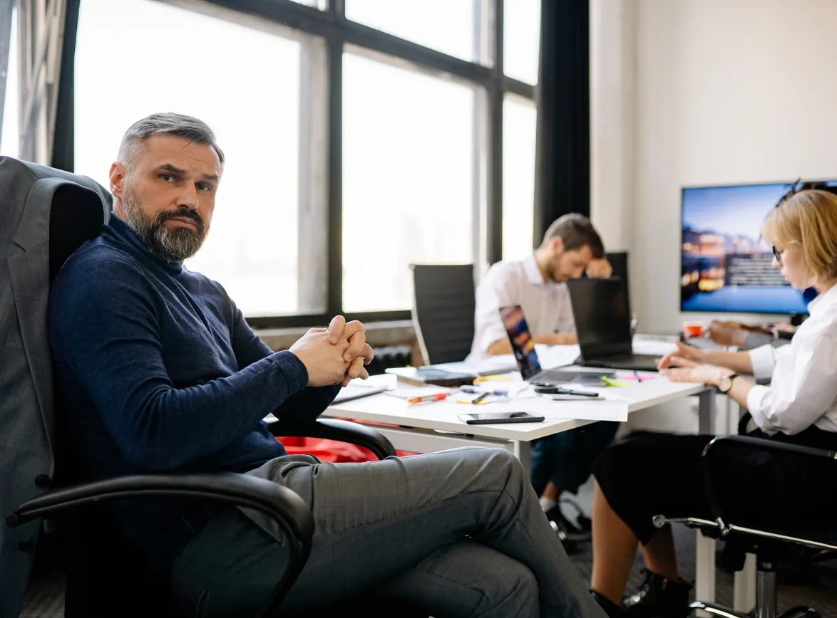 Co-workers engaging in a business discussion in a modern office setting