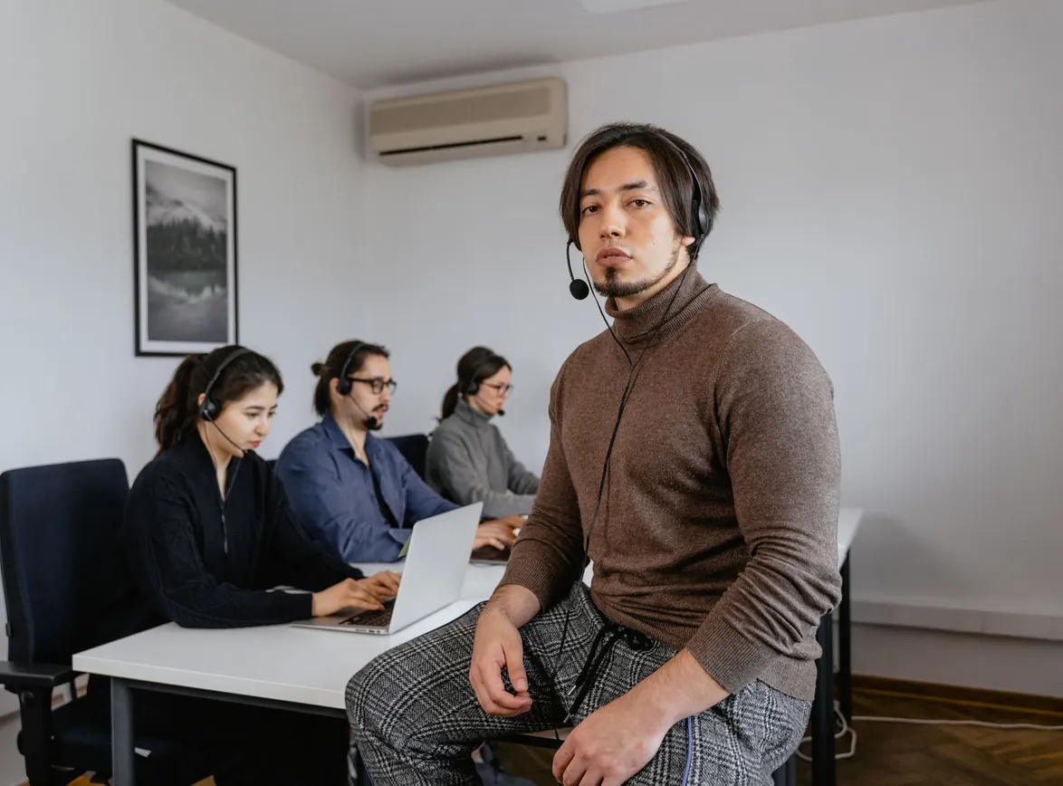 Focused call center team working together in a modern office space, collaborating on customer support tasks