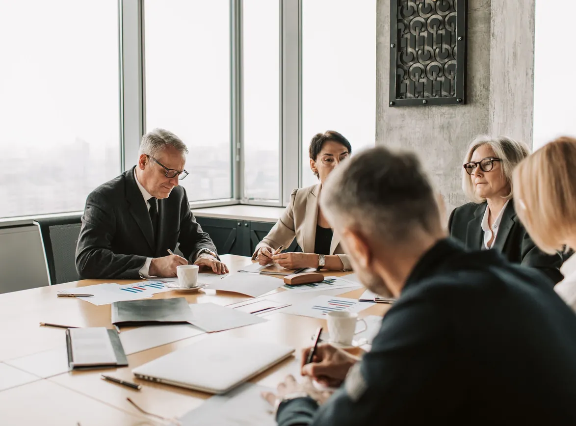 Business professionals engaged in a collaborative meeting around a conference table