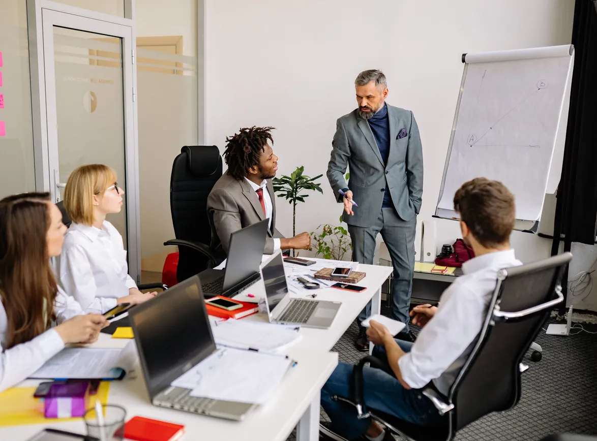 Corporate team in a modern office, engaged in a discussion with colleagues