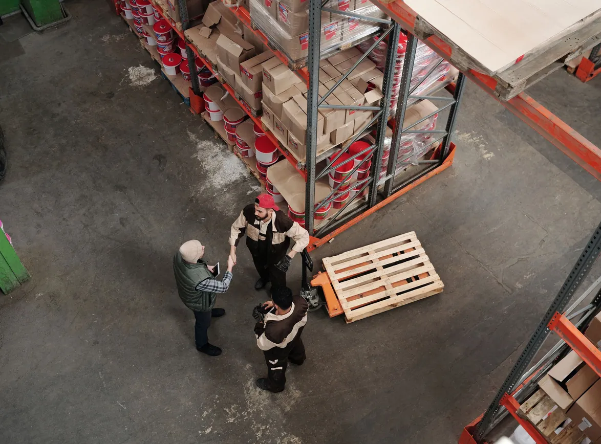 High angle view of workers discussing logistics in a warehouse setting