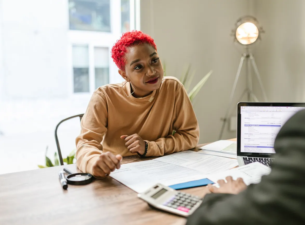 Professional woman engaged in thoughtful discussion at a business meeting indoors