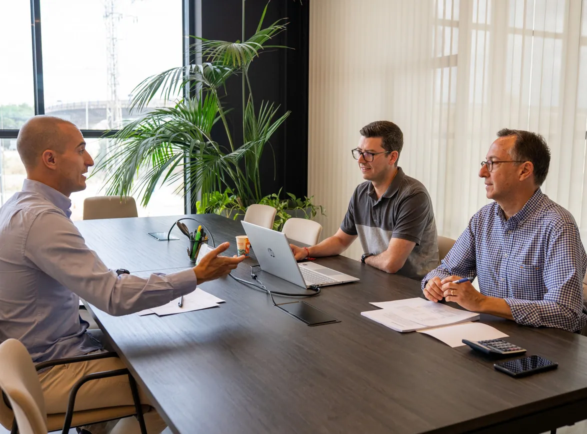 Professionals engaged in a collaborative business meeting at a modern office setting