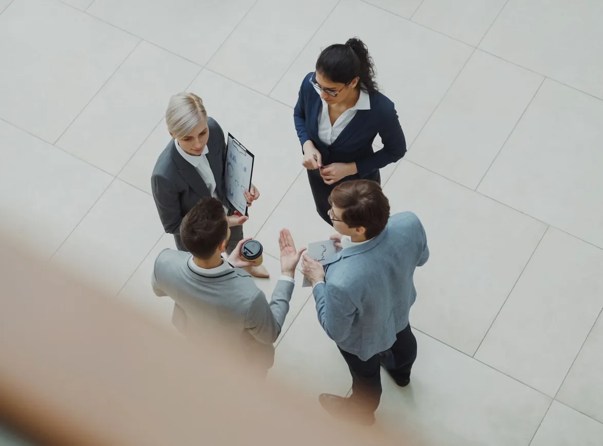 Overhead shot of business team discussing a project indoors