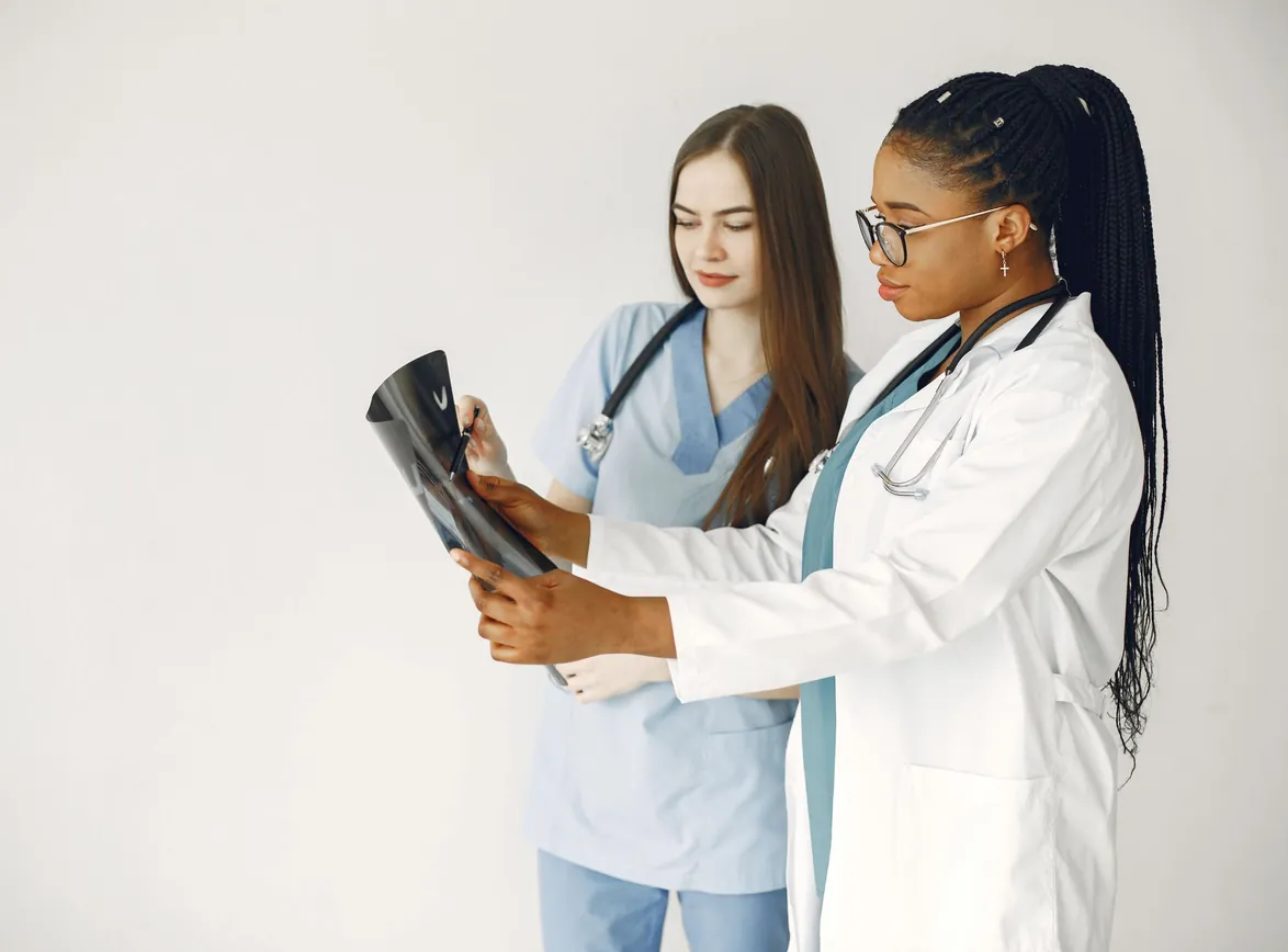 Two healthcare professionals review x-ray results in a clinical setting