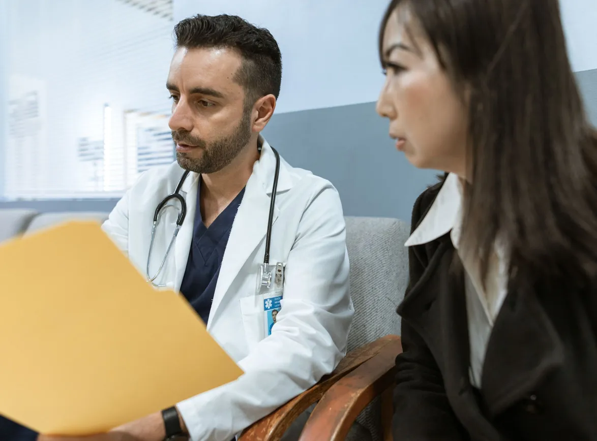 Doctor discusses notes with a colleague in a clinical setting