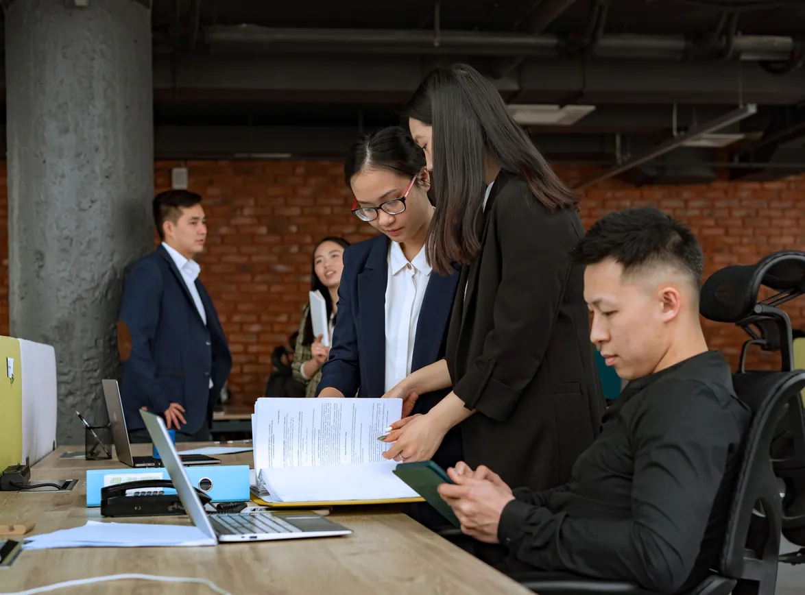 Professional team engaged in discussion and collaboration in a modern office environment