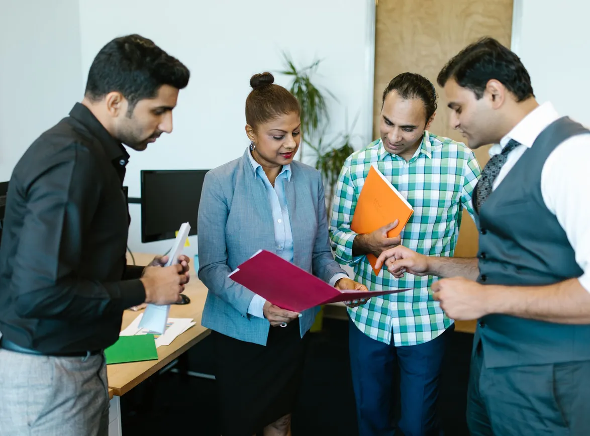 Business team engaged in discussion during a meeting in a modern office setting