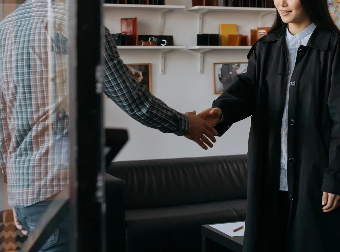 Two professionals engage in a handshake